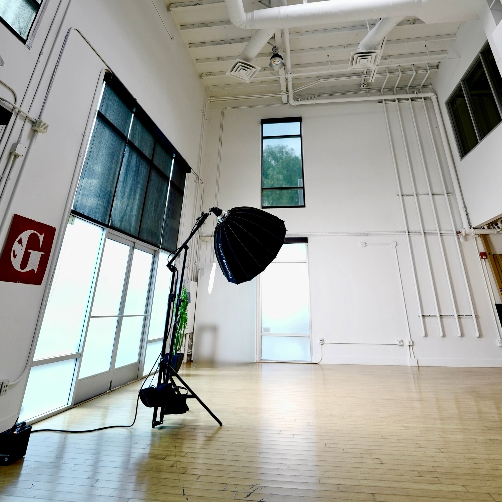 The Post Road Loft &mdash; the studio floor with strobe softbox under high ceilings and daylight.