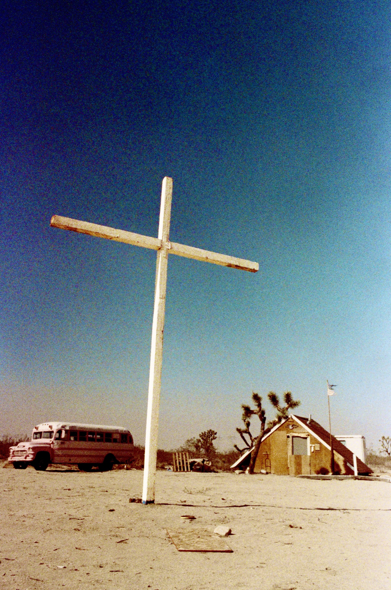 Wooden cross against deep blue sky, Mojave landscape
